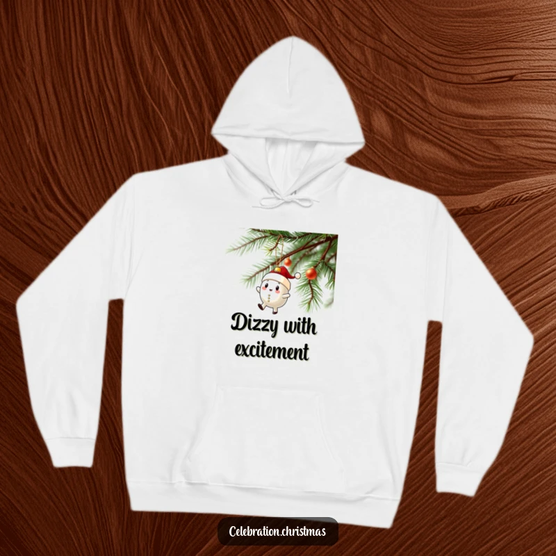 Funny hoodie designed with a Christmas ornament character performing a funny wobbly spin on a tree branch, spreading joy.